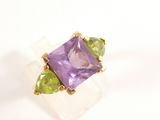 an image of a purple and green ring on a white surface