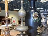 many vases and lamps on the table in the room