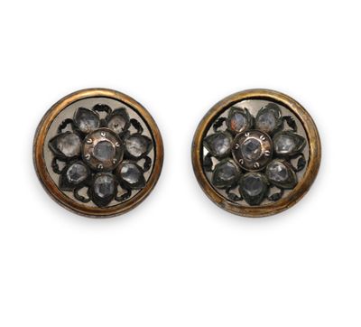 a pair of gold and diamond earrings