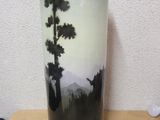 a vase that has a painting on it on a table