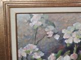 a painting of flowers in a gold frame on the wall