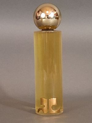 a bottle of perfume that has a gold ball on top of it