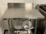 a kitchen with a stove, sink, and oven in it