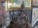 a statue of a man riding a horse in a glass case