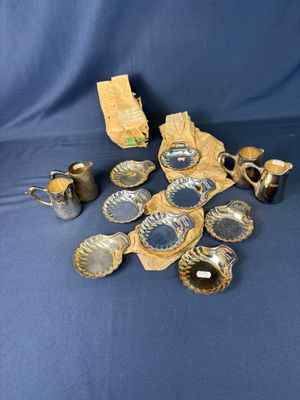 a pile of silverware on a blue cloth