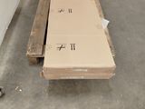 a large box sitting on a pallet in the middle of a room