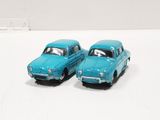 two toy cars that are sitting next to each other on a table