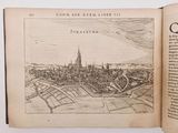 an open book with a drawing of a city on it