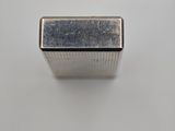 a close up of a metal object on a white surface