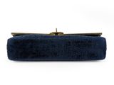 a blue velvet clutch bag with a gold clasp