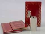 a red box with a lighter and a red book