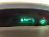 a close up of the dashboard of a car with a green light