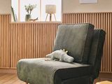 a chair with a stuffed animal on it in a living room