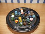 a black plate with a lot of marbles on it