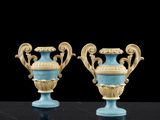 une paire de vases bleus et dorés posés sur une table noire