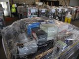 a large pile of items wrapped in plastic in a warehouse