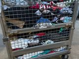 a metal cart with many pairs of shoes on it