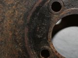 a rusted piece of metal with holes in it