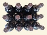 many bottles of wine that are stacked on top of each other