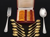 a box with a set of silverware on a black surface