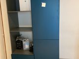 a blue cabinet in the corner of a room