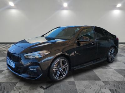 the bmw m140i coupe is parked on a checkered floor