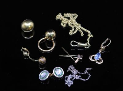 many different types of jewelry on a black surface