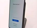 the back of a phone with a blue button on the display