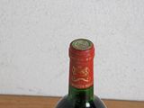 a bottle of wine sitting on top of a wooden table