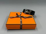 an orange box with a black belt and a silver buckle on it