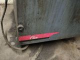 an image of a metal oven with a red sticker on it