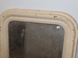 a mirror that is sitting on the wall in the room