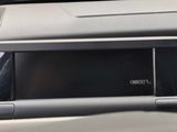 a close up of a car dashboard with a clock on it