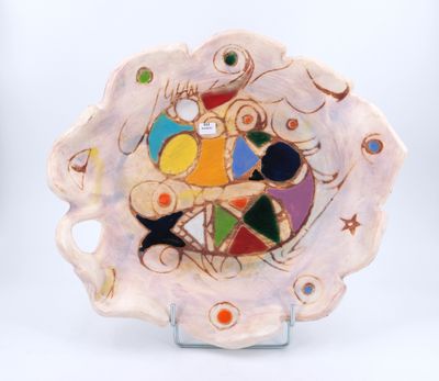 a plate with a colorful design on it on a stand