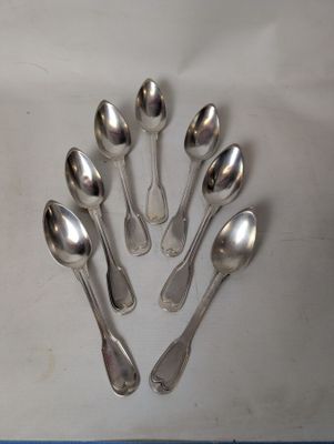 six spoons arranged in a circle on top of a table