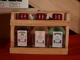 four bottles of sauce in a wooden box