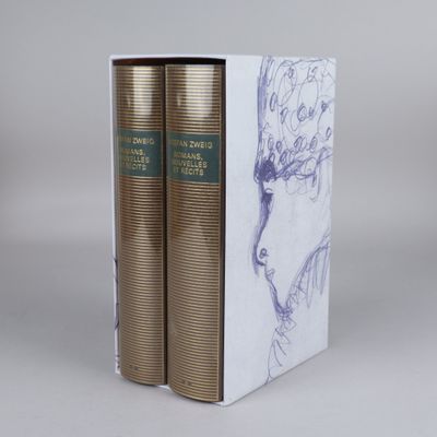 two books in a white box with a drawing of a woman ' s face on it