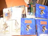 many books on a table with pictures on them