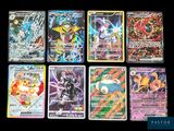 pokemon cards are lined up on a black surface