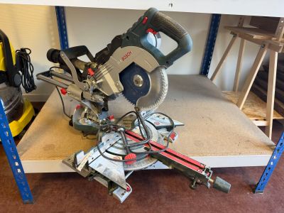 a picture of a miter saw on a shelf in a garage