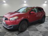 the red nissan rav is parked on a checkered floor