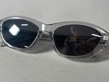 silver sunglasses with black lenses on a white surface