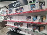 a lot of video games on the shelves in the store