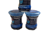 three jars of marine food sitting next to each other on a white surface