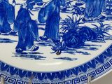 chinese blue and white porcelain plate with a scene of a group of people