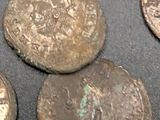 several old coins sitting on top of a table next to each other