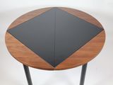 a small table with a black top on a white background