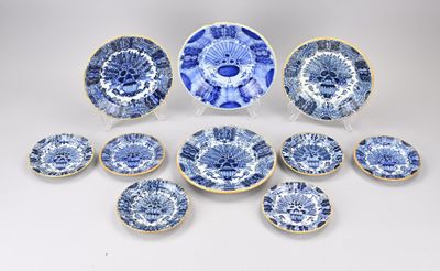several blue and white plates and bowls on a white surface