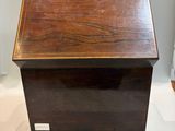 an old wooden box sitting on top of a white floor
