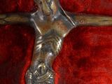 a metal crucifid with a crown on it